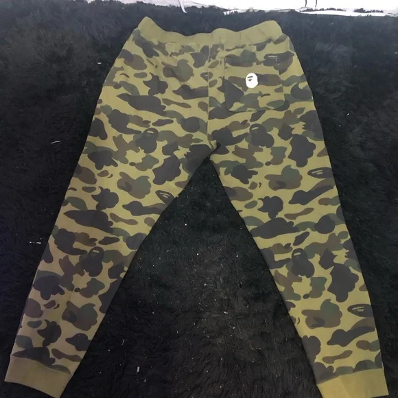 A BATHING APE GREEN 1ST CAMO SWEATS W/ EMBROIDERED LETTERS IN WHITE SZ. M